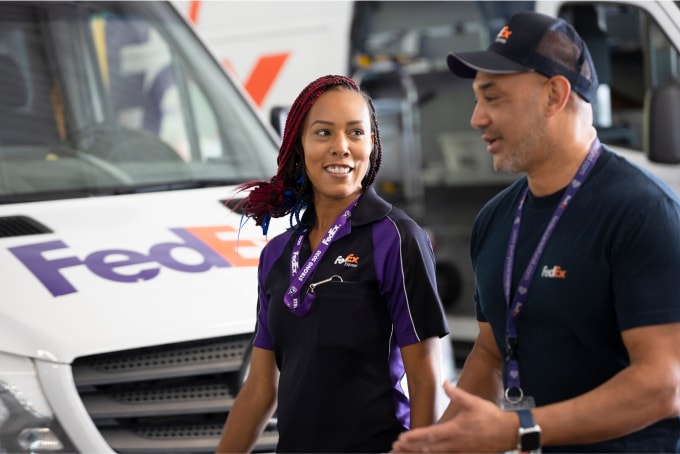 Two FedEx employees collaborating